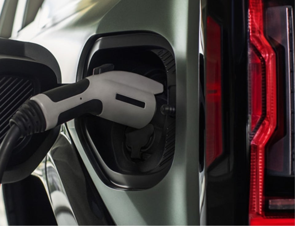 Close up of charging port with charger plugged in on a GMC Hummer EV SUV - Mario D'Addario Buick GMC in SHELTON CT